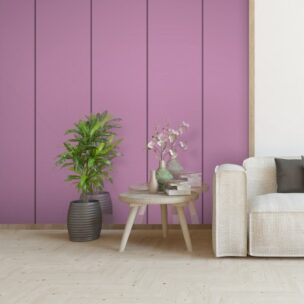 Modern living room with a purple accent wall and pink side table.